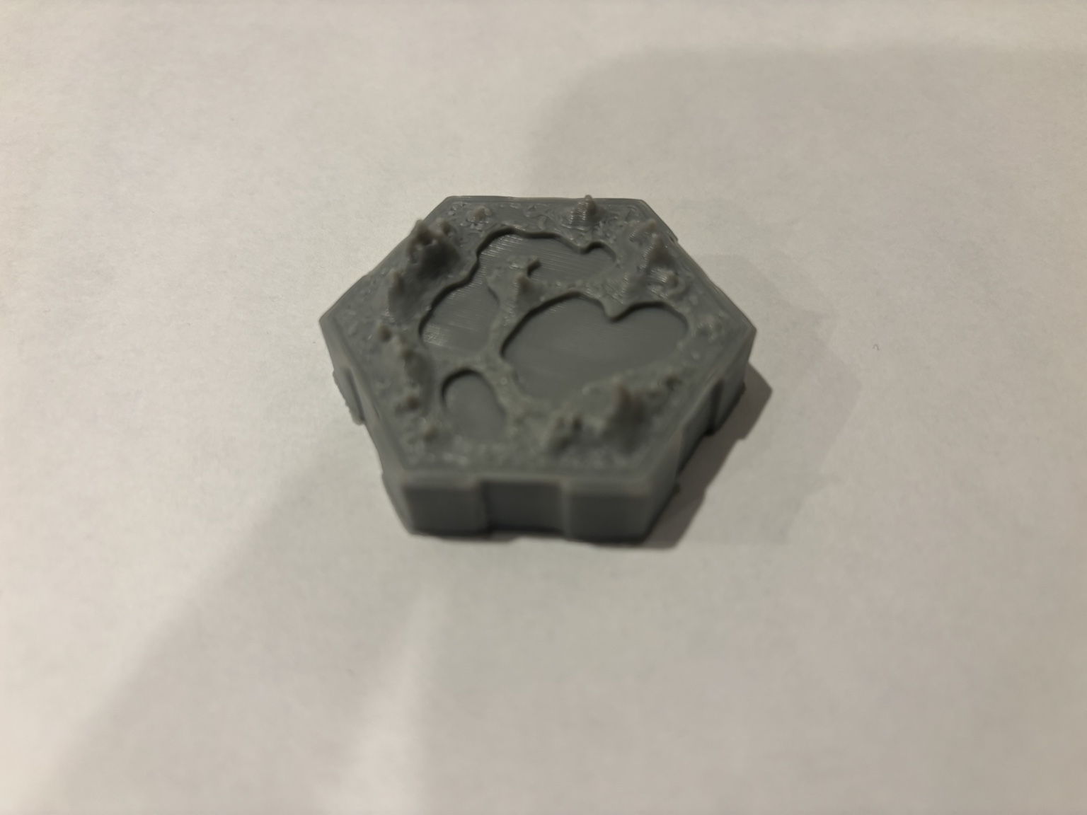 Gray 3D printed hexagonal terrain tile