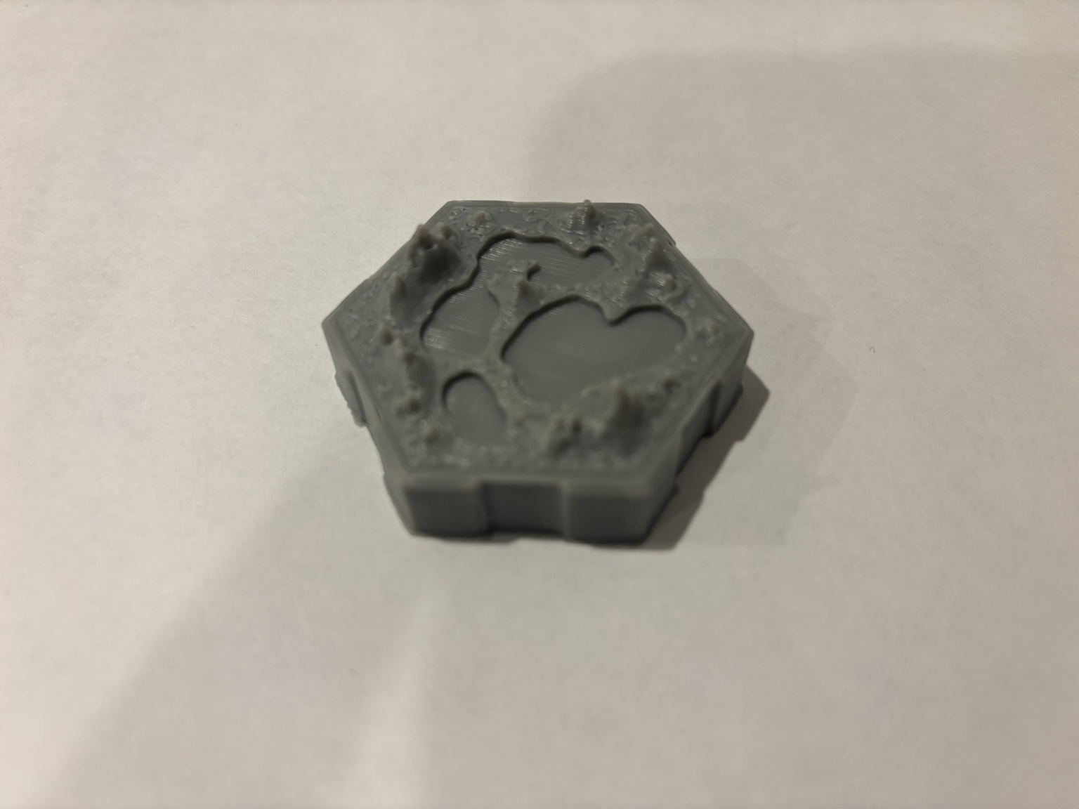 Printed terrain tile with raised topography